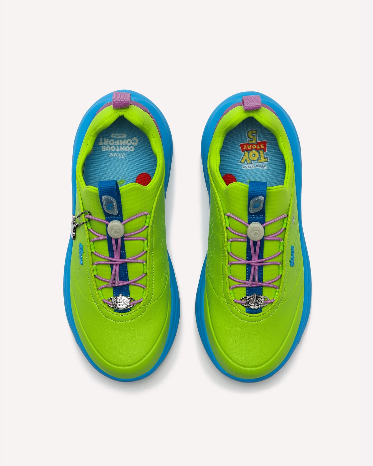 Pair of green and blue shoes with pink laces on a white background