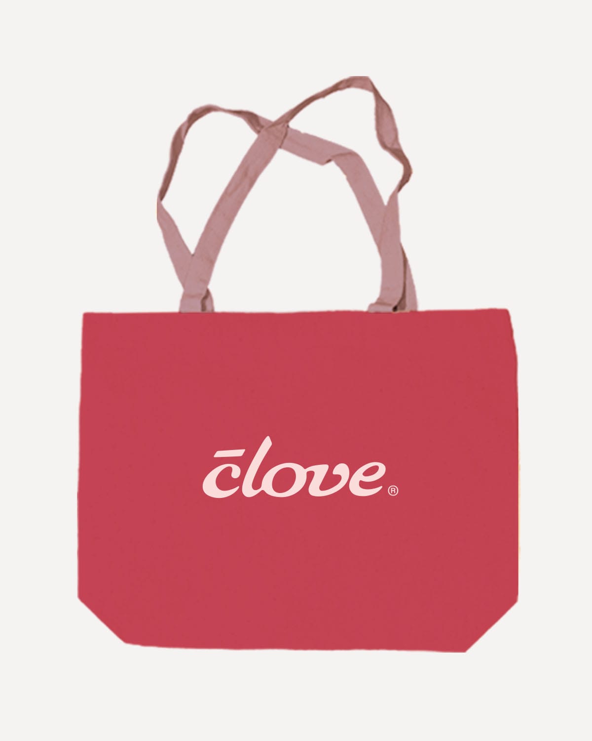 A red canvas tote bag with dusty pink handles and a white 'clove' logo printed on the front, shown against a light off-white background.