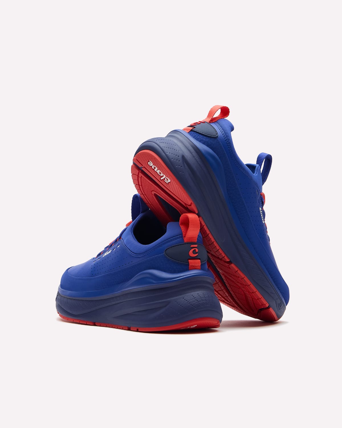 A pair of blue and red sneakers shown from a three-quarters angle against a light gray background.