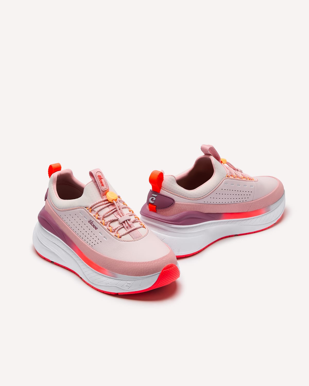 Pair of pink and red athletic shoes on a white background