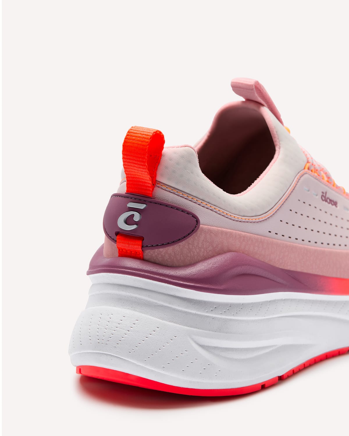 Pink and orange sneaker with a visible brand logo on a white background