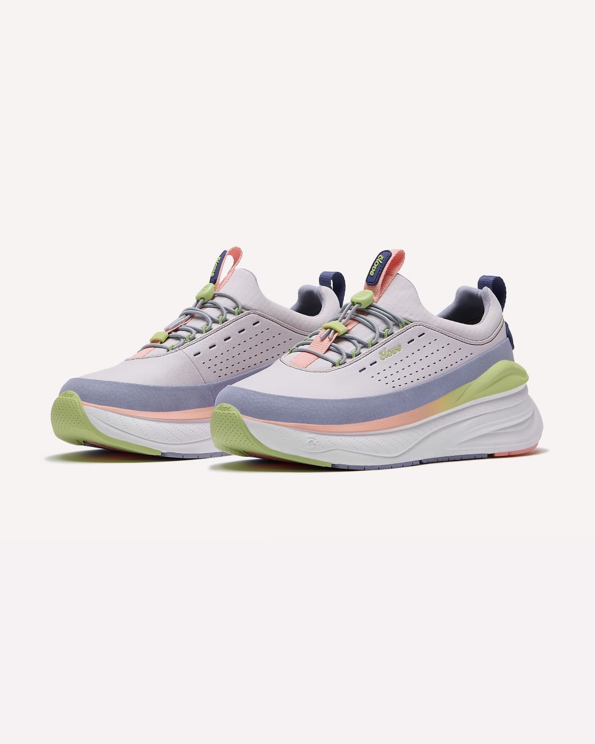 Pair of light gray running shoes with colorful accents on a white background