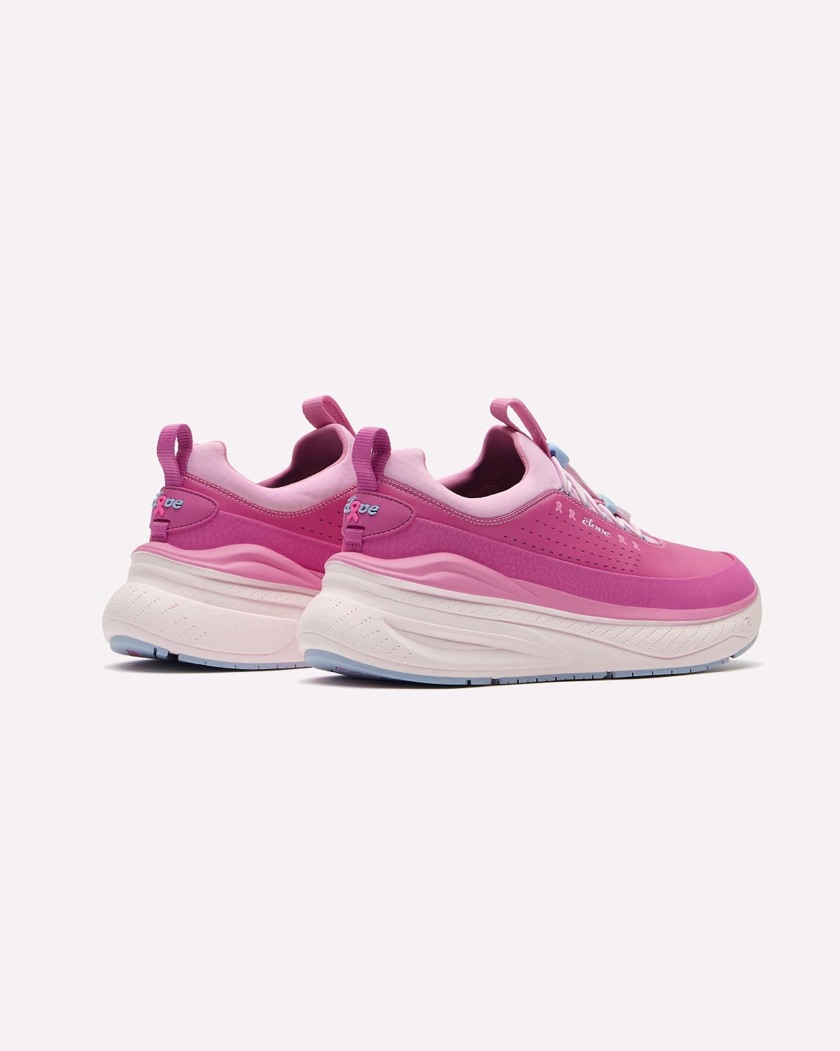 A pair of pink and magenta chunky platform sneakers with white bottoms and light blue bottoms, shown from a three-quarters angle on a light gray background.