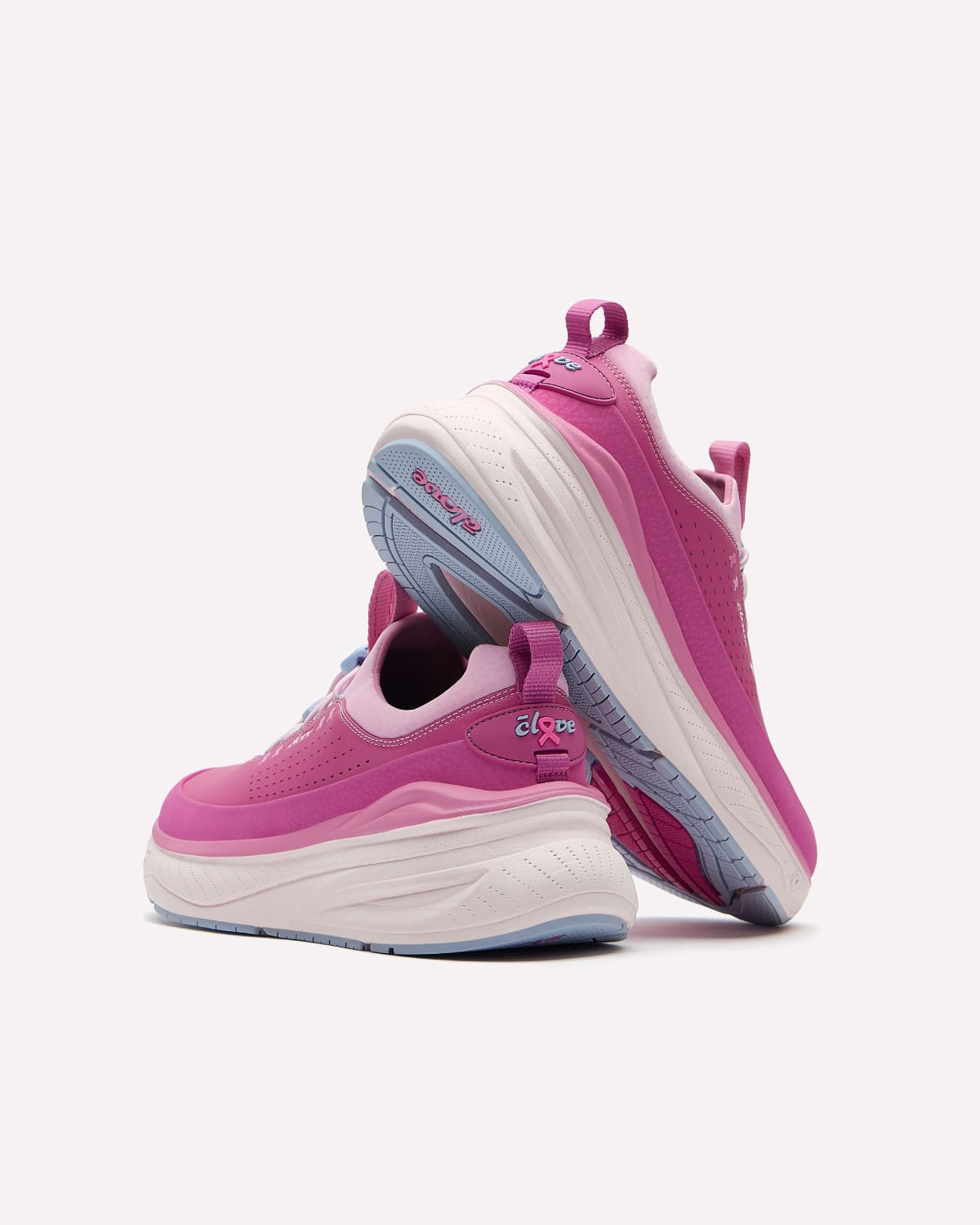 A pair of pink and white platform sneakers with light blue accents on the bottom, shown from a three-quarters angle against a light gray background.