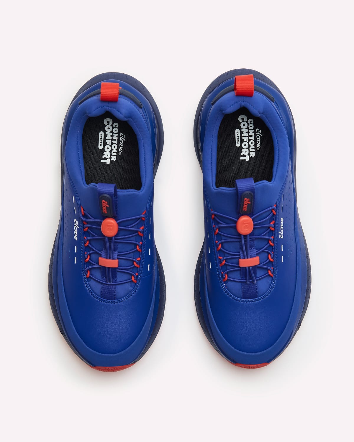 A pair of blue slip-on sneakers with red accents and black branding on the bottoms, shown from a top-down view on a light gray background.