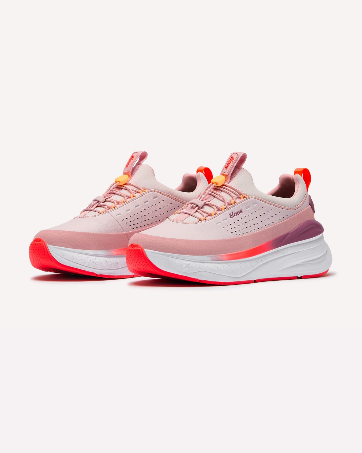 Pair of pink and orange running shoes on a white background