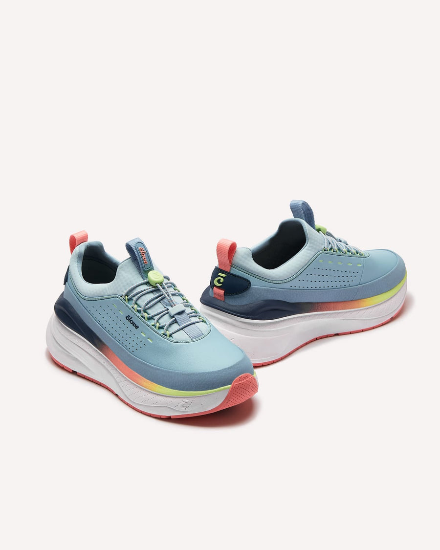 Pair of blue running shoes with colorful accents on a white background